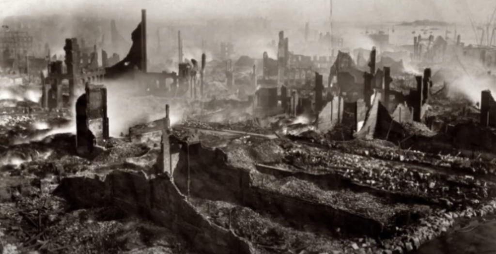 Fire-ravaged neighborhood with destroyed houses.