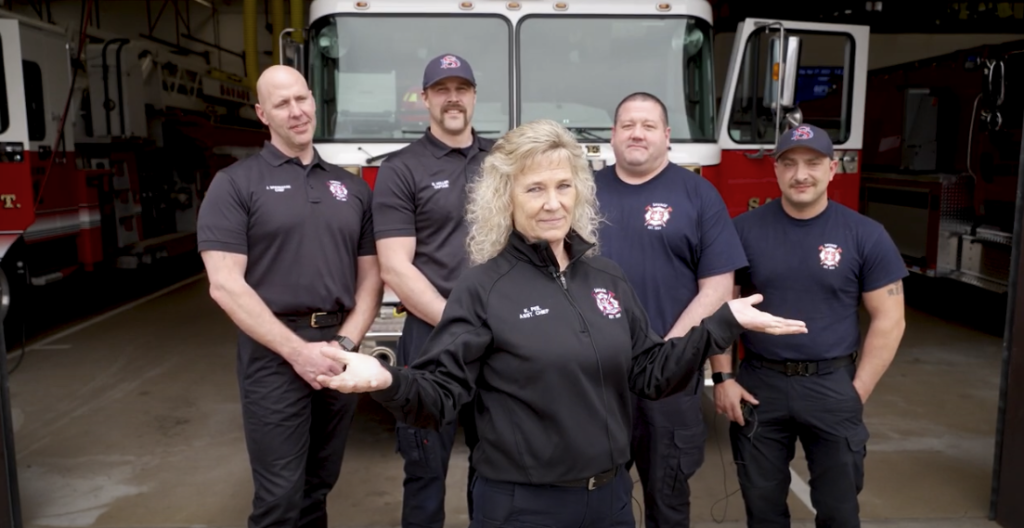 Firefighters in front of a fire truck